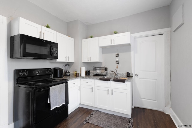 4411 Commercial Ave, Omaha, NE 68110 - kitchen featuring black appliances, dark wood-style floors, white cabinetry, and light stone counters