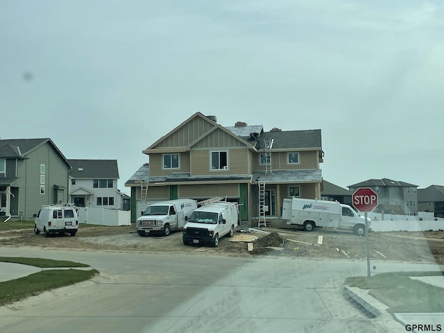 6515 S 199th Ave, Omaha, NE 68135 - view of concrete road featuring traffic signs and a residential view