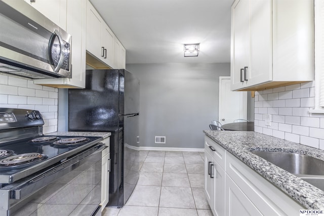 3185 Stone Ave, Omaha, NE 68111 - kitchen featuring black appliances, baseboards, backsplash, white cabinets, and light stone countertops
