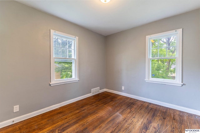 3185 Stone Ave, Omaha, NE 68111 - empty room with baseboards, healthy amount of natural light, and dark wood-style flooring