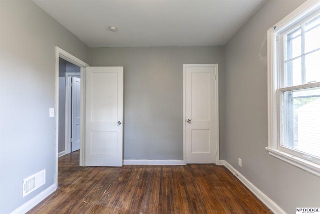 3185 Stone Ave, Omaha, NE 68111 - unfurnished bedroom featuring dark wood-style floors and baseboards