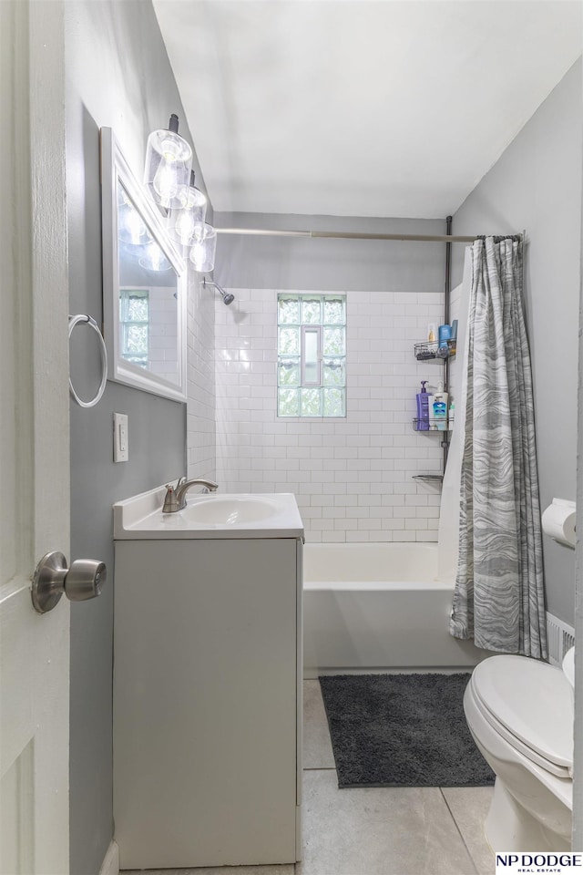 3185 Stone Ave, Omaha, NE 68111 - full bath featuring toilet, shower / bath combo with shower curtain, vanity, and tile patterned flooring