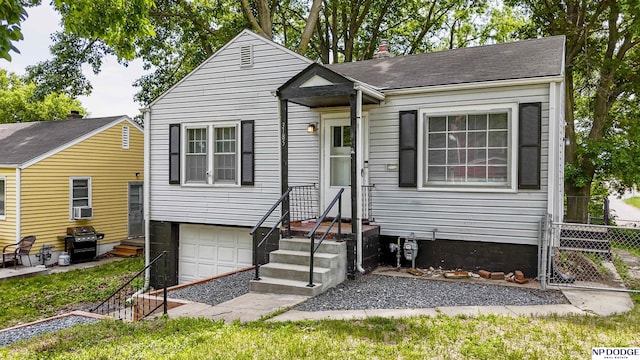 3185 Stone Ave, Omaha, NE 68111 - view of front of house featuring a garage and roof with shingles