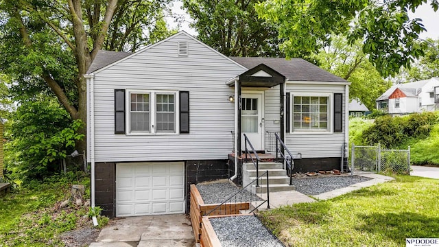 3185 Stone Ave, Omaha, NE 68111 - bungalow-style house with an attached garage, driveway, and roof with shingles