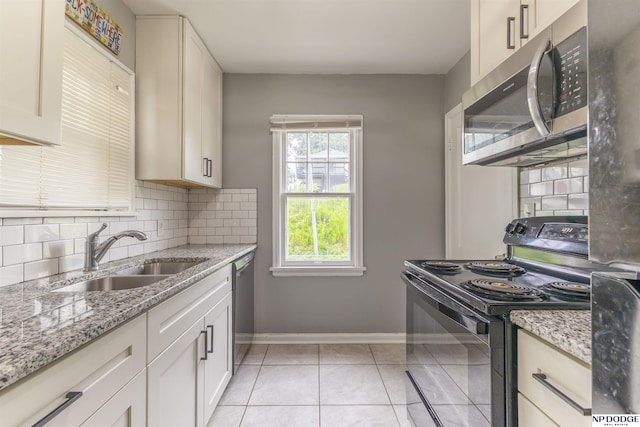3185 Stone Ave, Omaha, NE 68111 - kitchen featuring appliances with stainless steel finishes, a sink, backsplash, and baseboards