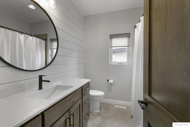 3310 N 92nd St, Lincoln, NE 68507 - full bathroom with vanity, toilet, baseboards, and wooden walls