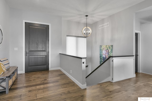 3310 N 92nd St, Lincoln, NE 68507 - foyer entrance with hardwood / wood-style flooring, a chandelier, and baseboards