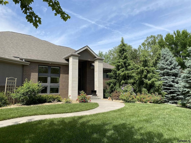 6500 Pheasant Run Ct, Lincoln, NE 68516 - view of front of house with brick siding, a shingled roof, and a front yard