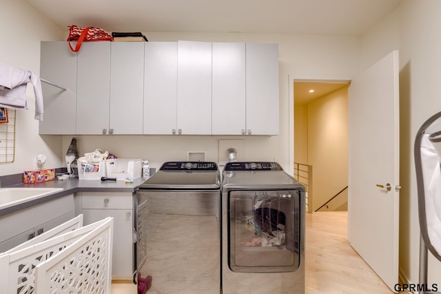 6500 Pheasant Run Ct, Lincoln, NE 68516 - laundry area featuring washer and clothes dryer, cabinet space, light wood finished floors, and recessed lighting