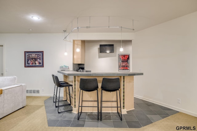6500 Pheasant Run Ct, Lincoln, NE 68516 - kitchen with a kitchen bar, baseboards, recessed lighting, a peninsula, and hanging light fixtures
