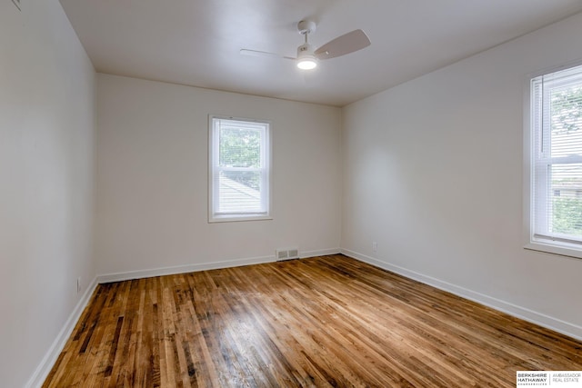 3121 State St, Omaha, NE 68112 - unfurnished room featuring plenty of natural light, wood finished floors, ceiling fan, and baseboards
