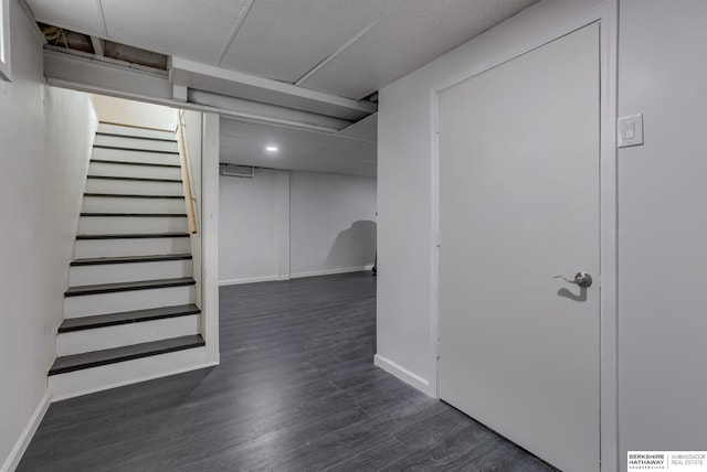 3121 State St, Omaha, NE 68112 - finished basement featuring stairway, baseboards, and dark wood-style floors