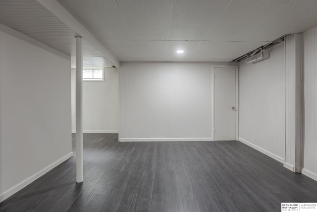 3121 State St, Omaha, NE 68112 - below grade area featuring dark wood-type flooring, baseboards, and a paneled ceiling
