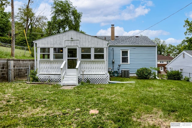 3121 State St, Omaha, NE 68112 - back of property with a chimney, central air condition unit, roof with shingles, and a wooden deck