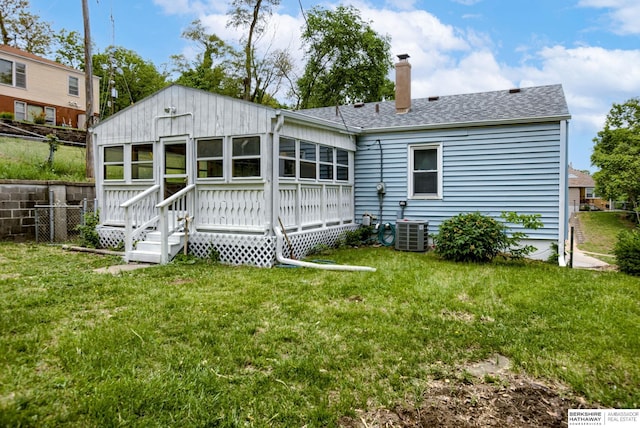 3121 State St, Omaha, NE 68112 - back of property featuring a chimney, central AC, and a shingled roof