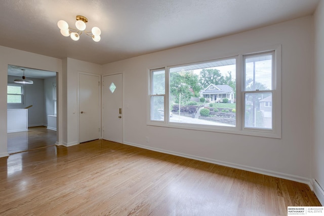 3121 State St, Omaha, NE 68112 - foyer entrance with baseboards, light wood-type flooring, and a chandelier