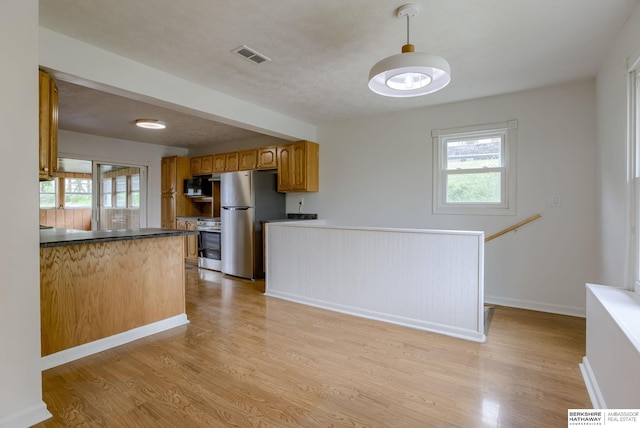 3121 State St, Omaha, NE 68112 - kitchen featuring stainless steel appliances, light wood-style flooring, healthy amount of natural light, and brown cabinets