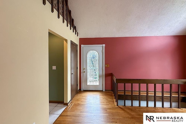2203 Beaver Lake Blvd, Plattsmouth, NE 68048 - entrance foyer featuring a textured ceiling, wood finished floors, and baseboards