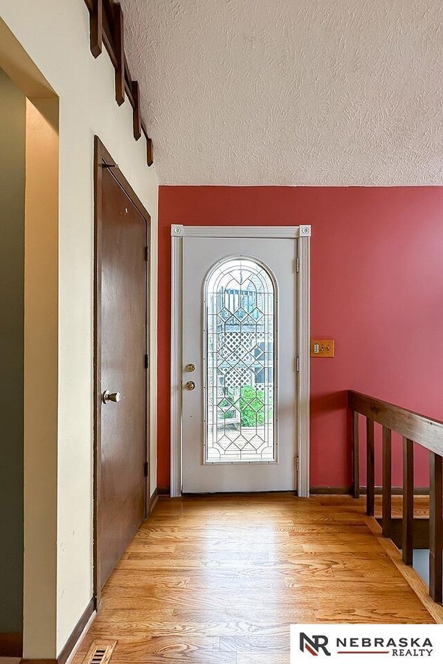 2203 Beaver Lake Blvd, Plattsmouth, NE 68048 - foyer with a textured ceiling and light wood finished floors
