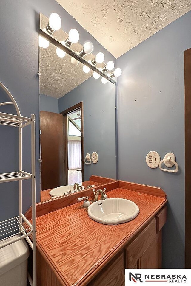 2203 Beaver Lake Blvd, Plattsmouth, NE 68048 - bathroom with a textured ceiling, vanity, and toilet