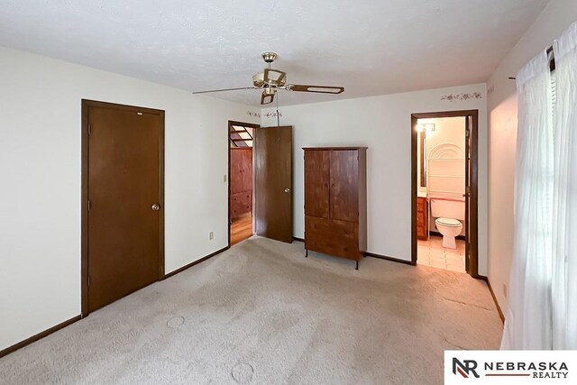 2203 Beaver Lake Blvd, Plattsmouth, NE 68048 - unfurnished bedroom with light colored carpet, ensuite bathroom, ceiling fan, and baseboards