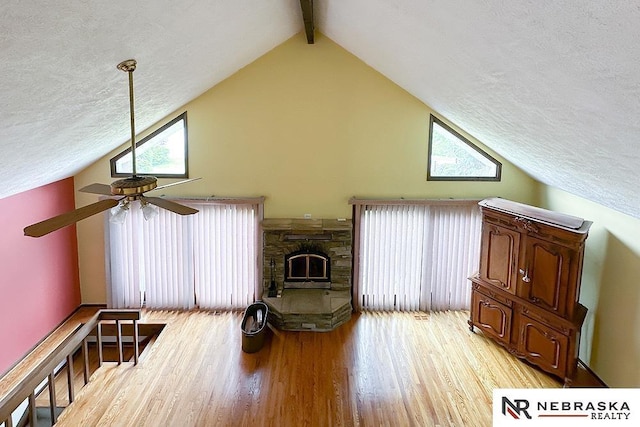 2203 Beaver Lake Blvd, Plattsmouth, NE 68048 - living area featuring ceiling fan, high vaulted ceiling, light wood finished floors, a textured ceiling, and beam ceiling