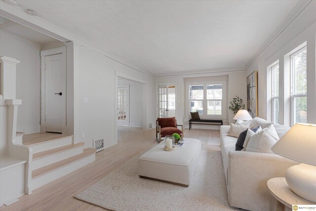 5009 Burt St, Omaha, NE 68132 - living area with light wood finished floors, ornamental molding, stairs, and baseboards