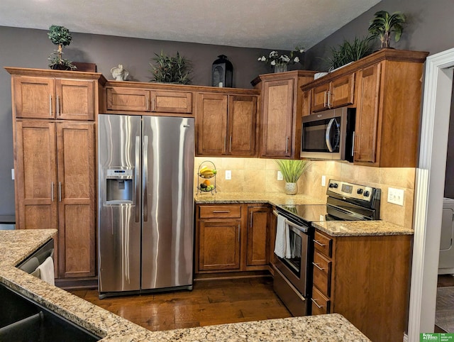 948 S 183rd St, Elkhorn, NE 68022 - kitchen featuring appliances with stainless steel finishes, dark wood-type flooring, and brown cabinetry