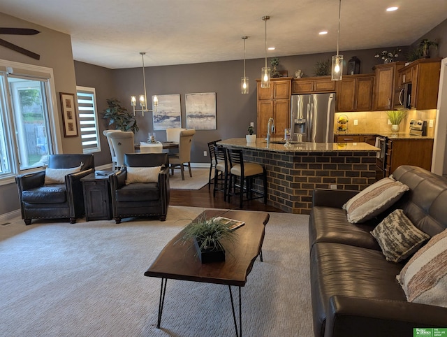 948 S 183rd St, Elkhorn, NE 68022 - carpeted living area with baseboards, recessed lighting, a ceiling fan, a sink, and a chandelier