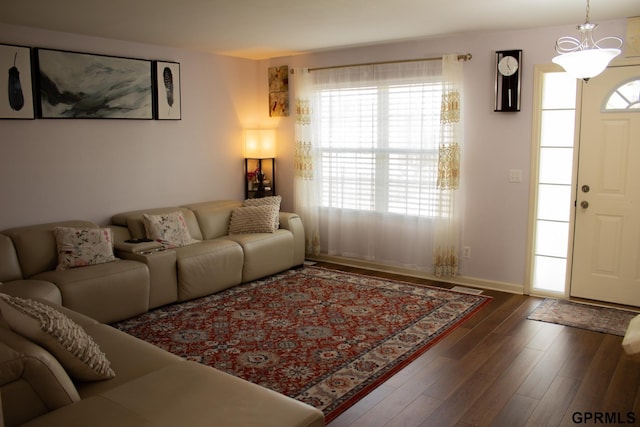 7014 N 89th St, Omaha, NE 68122 - living room featuring wood finished floors, a chandelier, and baseboards