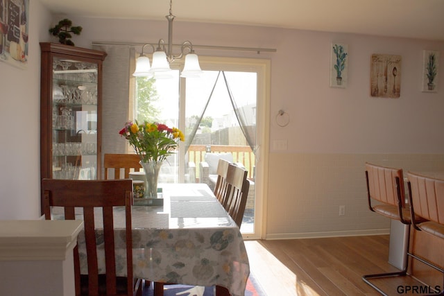 7014 N 89th St, Omaha, NE 68122 - dining room with wood finished floors, a chandelier, and wainscoting