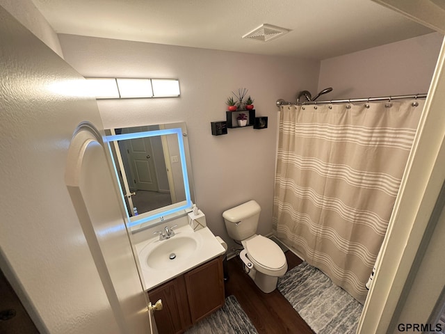 7014 N 89th St, Omaha, NE 68122 - bathroom with toilet, vanity, wood finished floors, and curtained shower