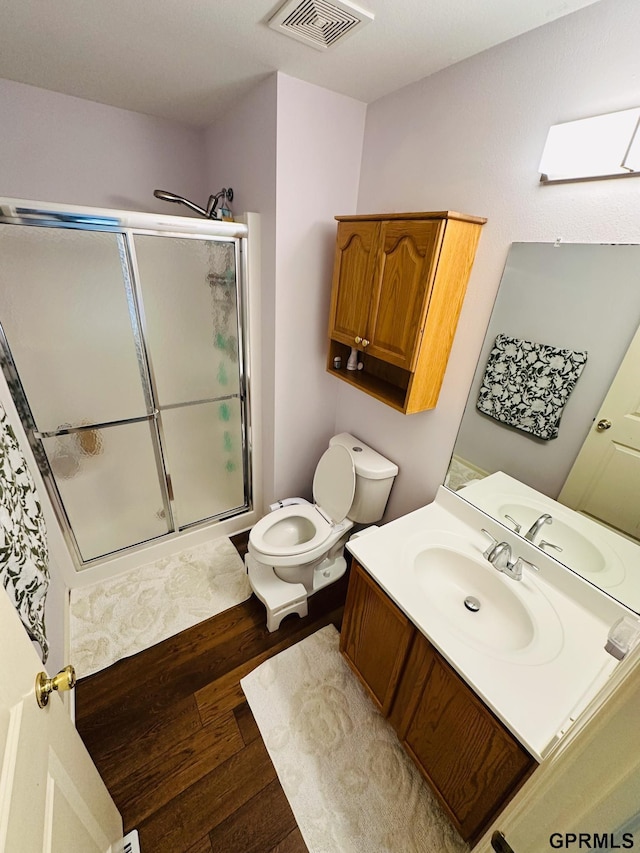 7014 N 89th St, Omaha, NE 68122 - full bath with vanity, wood finished floors, a stall shower, and toilet