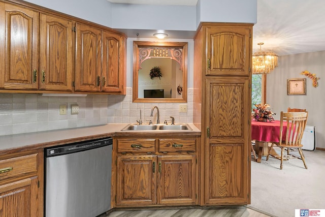 7432 Grand Oaks Dr, Lincoln, NE 68516 - kitchen featuring dishwasher, a sink, brown cabinets, and a chandelier