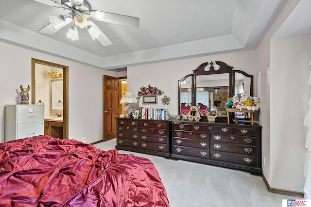 7432 Grand Oaks Dr, Lincoln, NE 68516 - carpeted bedroom with connected bathroom, ceiling fan, a tray ceiling, and baseboards