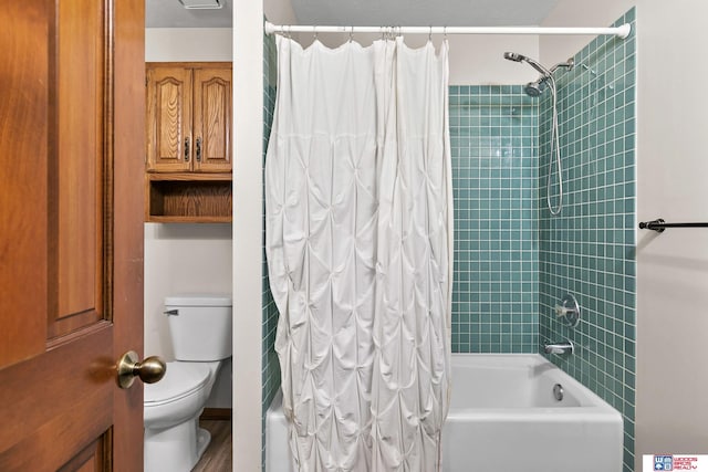 7432 Grand Oaks Dr, Lincoln, NE 68516 - bathroom featuring shower / bath combo with shower curtain and toilet