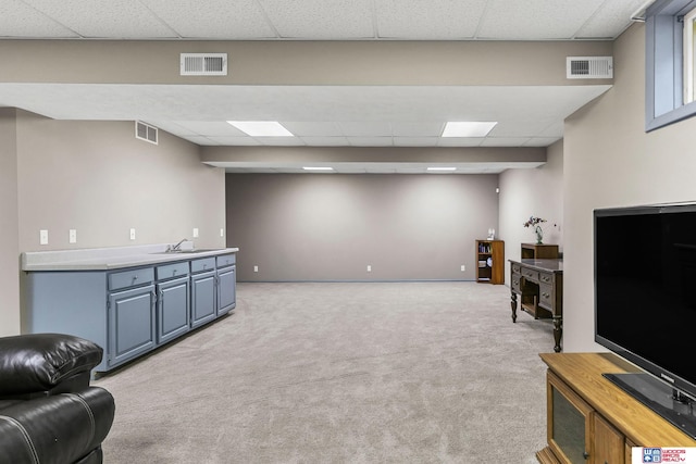 7432 Grand Oaks Dr, Lincoln, NE 68516 - living area featuring a drop ceiling, light colored carpet, and baseboards