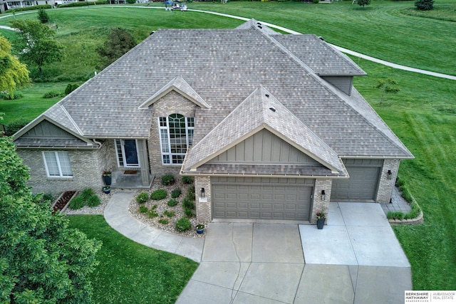 9711 S 176th St, Omaha, NE 68136 - view of front of house featuring brick siding, roof with shingles, an attached garage, and concrete driveway