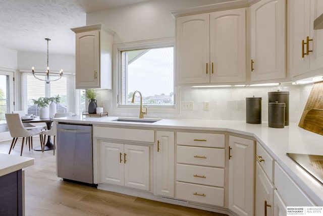 9711 S 176th St, Omaha, NE 68136 - kitchen featuring stainless steel dishwasher, a sink, backsplash, a chandelier, and light countertops