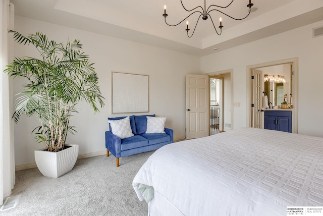 9711 S 176th St, Omaha, NE 68136 - carpeted bedroom with a chandelier, a tray ceiling, baseboards, and connected bathroom