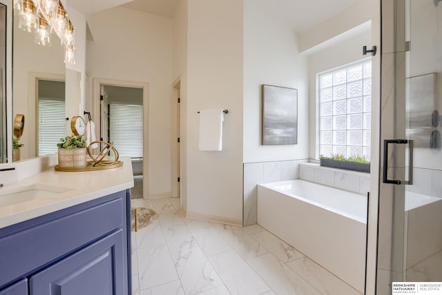 9711 S 176th St, Omaha, NE 68136 - full bath with vanity, a garden tub, marble finish flooring, a stall shower, and baseboards