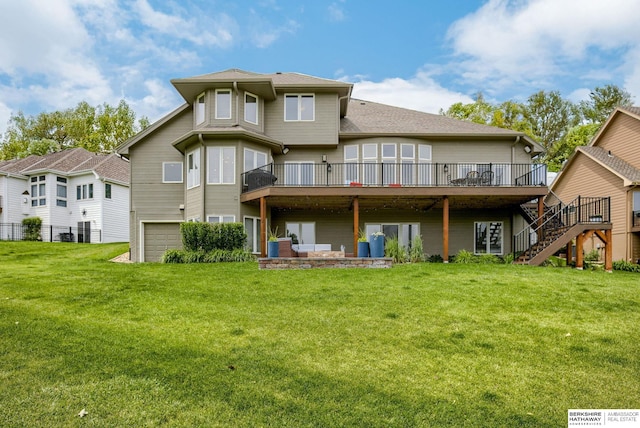 9711 S 176th St, Omaha, NE 68136 - rear view of house featuring a deck, an attached garage, stairway, and a lawn