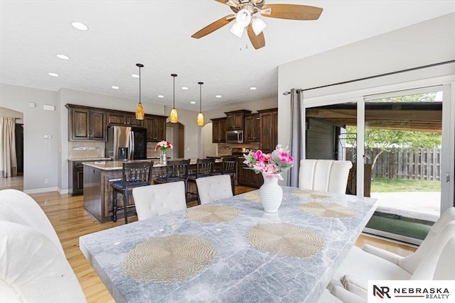 18402 Polk St, Omaha, NE 68135 - dining area with arched walkways, recessed lighting, a ceiling fan, light wood-type flooring, and baseboards