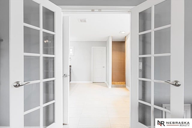 18402 Polk St, Omaha, NE 68135 - corridor featuring french doors, tile patterned flooring, and baseboards
