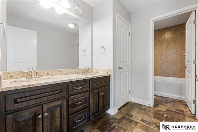 18402 Polk St, Omaha, NE 68135 - full bathroom with baseboards, double vanity, and stone finish floors