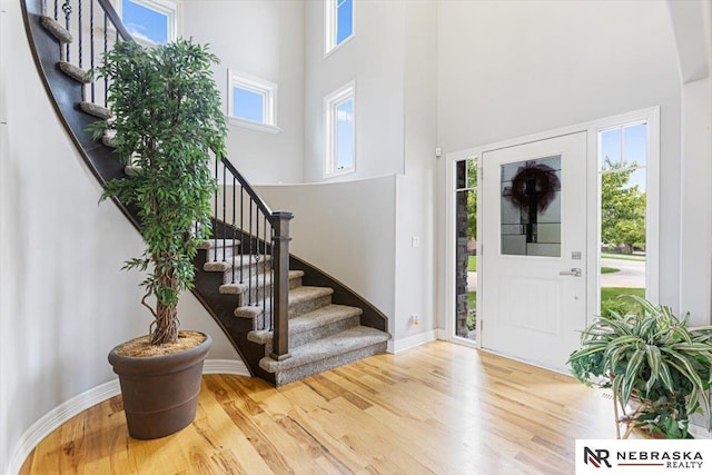 18402 Polk St, Omaha, NE 68135 - foyer featuring a high ceiling, stairway, wood finished floors, and healthy amount of natural light