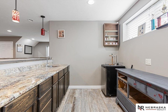 18402 Polk St, Omaha, NE 68135 - kitchen with a sink, light wood-style floors, baseboards, recessed lighting, and hanging light fixtures