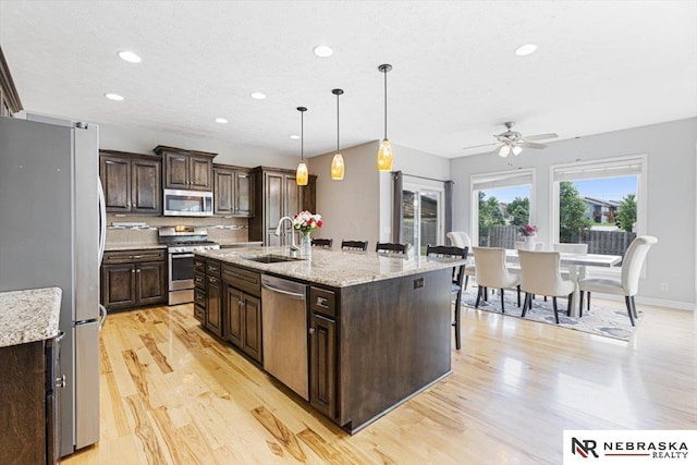 18402 Polk St, Omaha, NE 68135 - kitchen with stainless steel appliances, a sink, light wood-type flooring, recessed lighting, and a ceiling fan