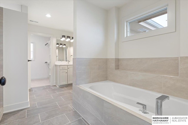 17018 Daniel St, Bennington, NE 68007 - full bath featuring a bath, vanity, tile patterned flooring, and recessed lighting