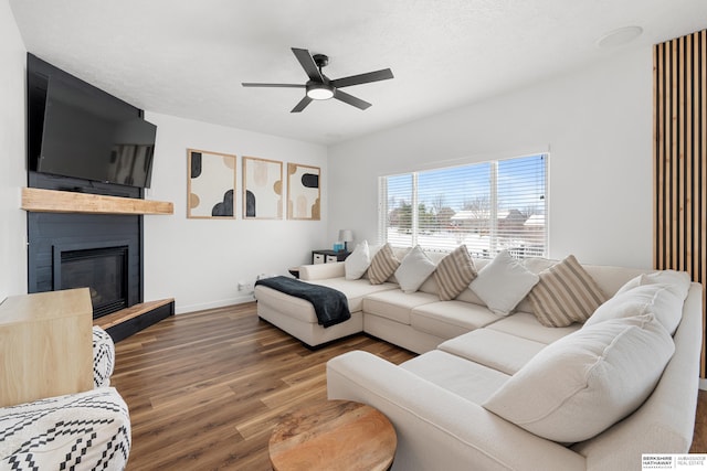 4706 S 187th Ave, Omaha, NE 68135 - living room with wood finished floors, ceiling fan, a large fireplace, and baseboards